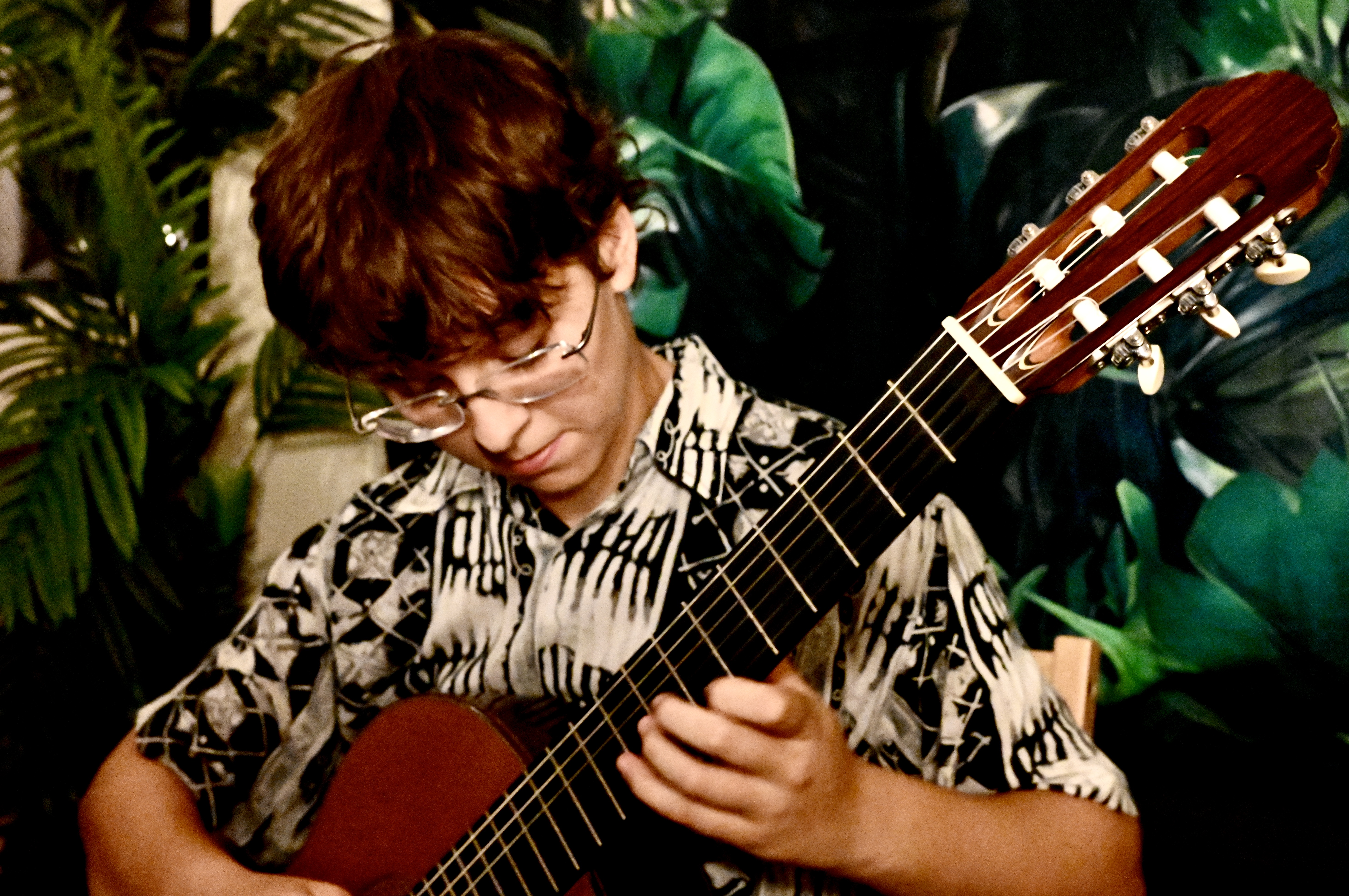 Bente Playing Guitar with scenic rainforest background